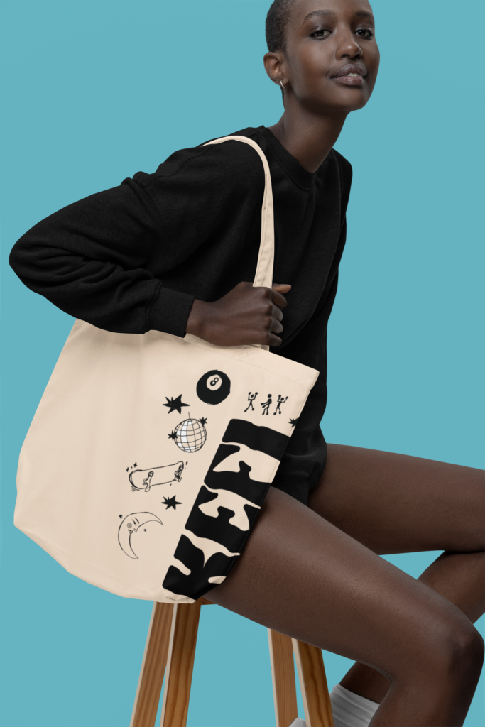 sublimated econscious tote bag mockup of a woman sitting on a stool m35459